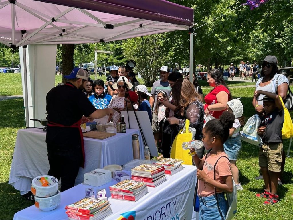 Cooking demonstration at outdoor community event.