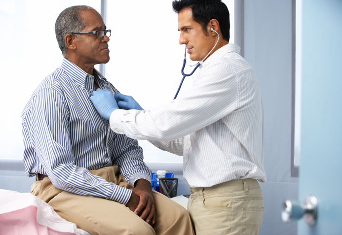doctor listening to a patient's heartbeat in doctor office