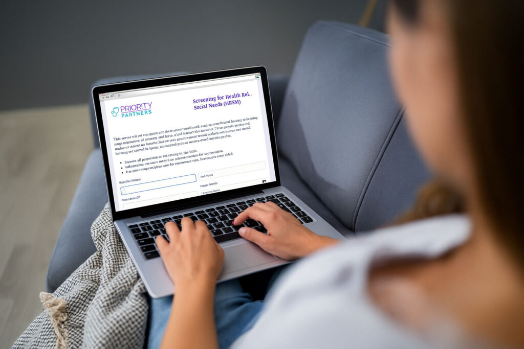 hands on laptop completing an online survey