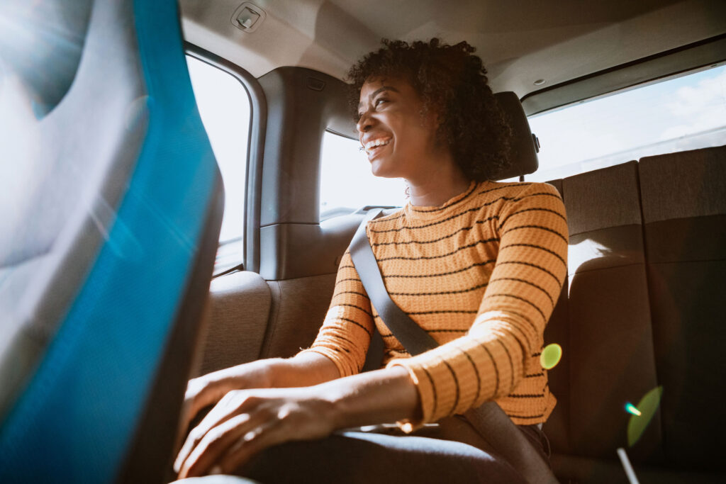 woman passenger riding in the backseat of a car