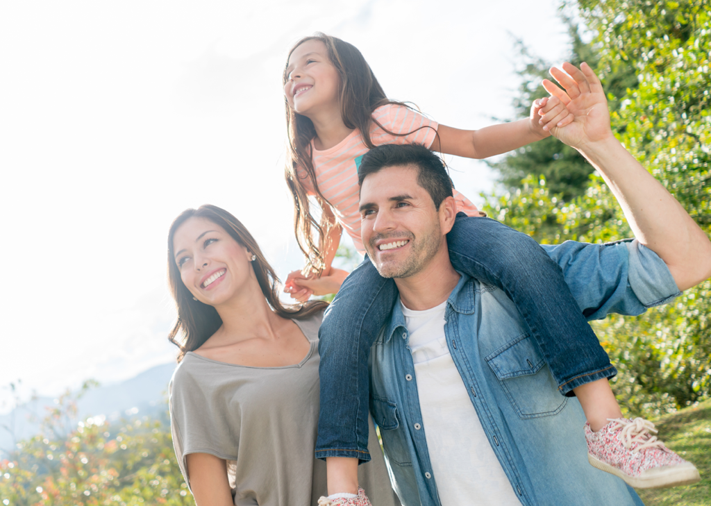 young family of 3 outdoors on a nice day